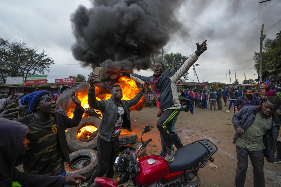 Shouting "No Raila No Peace," Kenyan opposition leader Raila Odinga supporters burn tires in the Kibera neighborhood of Nairobi, Kenya, Monday, Aug. 15, 2022. Kenya’s electoral commission chairman has declared Deputy President William Ruto the winner of the close presidential election over five-time contender Raila Odinga, a triumph for the man who shook up politics by appealing to struggling Kenyans on economic terms and not on traditional ethnic ones. (AP Photo/Ben Curtis)