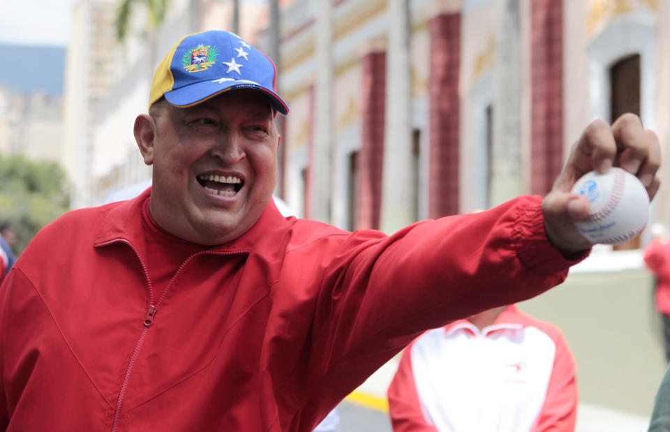 File - In this Thursday Sept. 29, 2011 file photo released by Miraflores Press Office, Venezuela's President Hugo Chavez holds out a baseball outside the presidential palace in Caracas, Venezuela. Throughout his presidency, Chavez has relied on his vigor and endurance: playing baseball and speaking for hours at a stretch. Now Chavez finds himself ailing as he heads into a re-election campaign against Henrique Capriles, a 39-year-old state governor who represents a younger and more energetic option, said Diego Moya-Ocampos, an analyst with the London-based consulting firm IHS Global Insight. (AP Photo/Miraflores Press Office, File)