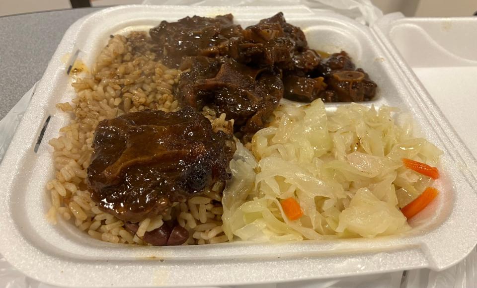 Jamaican Jerk Center serves saucy ox tails with rice and cabbage.