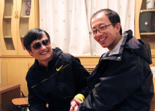 An undated photo shows outspoken government critic Hu Jia (R) sharing a light moment with blind lawyer Chen Guangcheng after his escape, at an undisclosed location in Beijing. Hu, who was detained over the weekend for questioning in the affair, also said Chinese security officials indicated that Chen had met with US ambassador Gary Locke since the activist's dramatic flight from house arrest