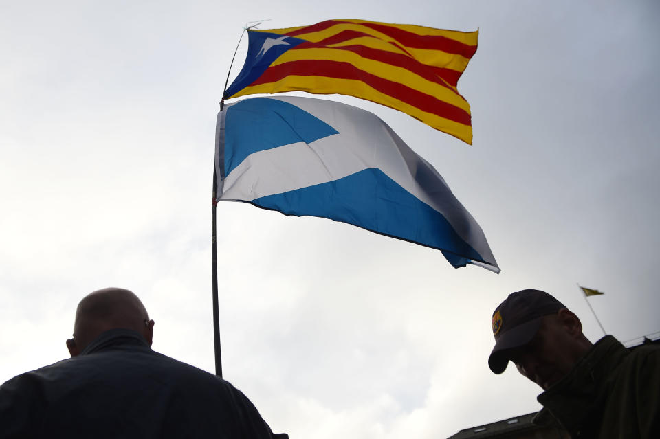 A Scottish saltire being flown alongside a Catalan independence flag in Glasgow (Getty)