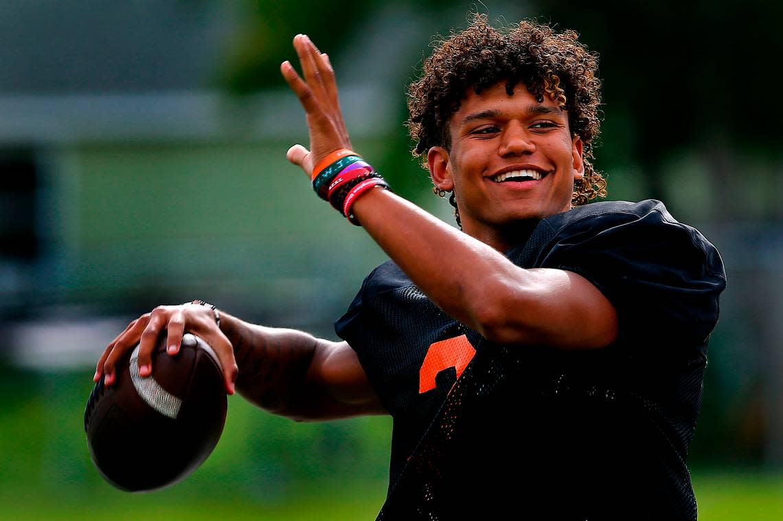 Kennewick High School quarterback Andre Breedlove wears a smile while warming up his throwing arm during a recent practice.