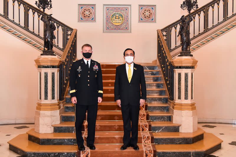 U.S. Army Chief of Staff General McConville and Thailand's PM Prayuth Chan-ocha pose during their meeting at Government House in Bangkok