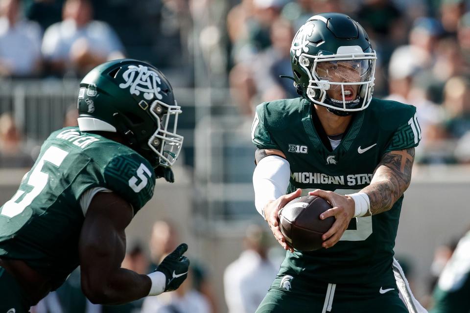 Michigan State quarterback Noah Kim (10) hands the ball to running back Nathan Carter (5) during the first half at Spartan Stadium in East Lansing on Saturday, Sept. 23, 2023.