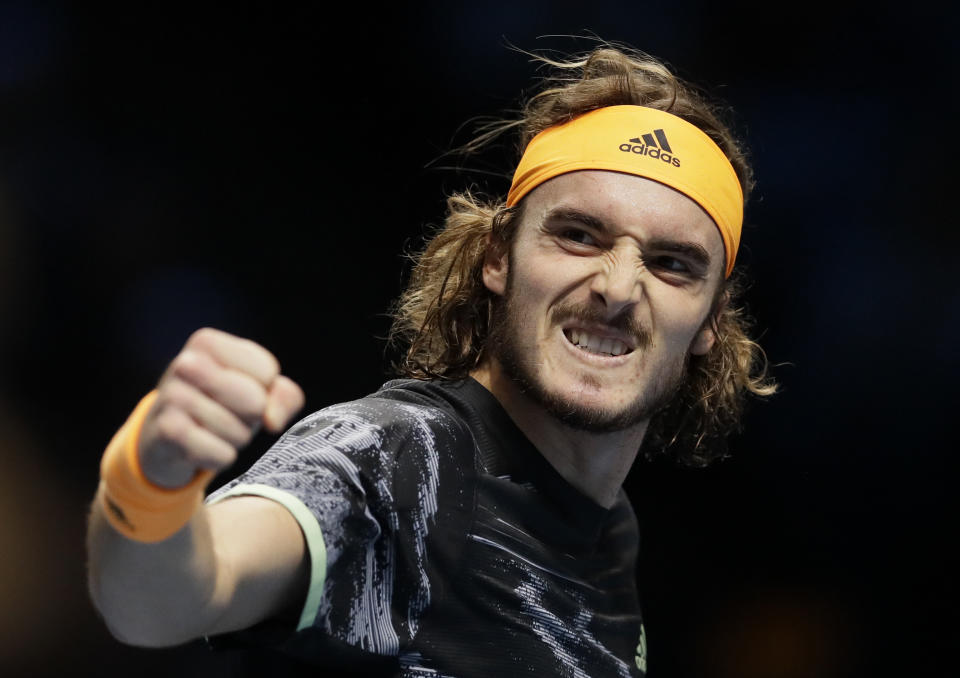 FILE - In this Nov. 11, 2019, file photo, Stefanos Tsitsipas of Greece celebrates winning a point against Daniil Medvedev of Russia during their ATP World Tour Finals singles tennis match at the O2 Arena in London. Tsitsipas is scheduled to play in the U.S. Open, scheduled for Aug. 31-Sept. 13, 2020.(AP Photo/Kirsty Wigglesworth, File)
