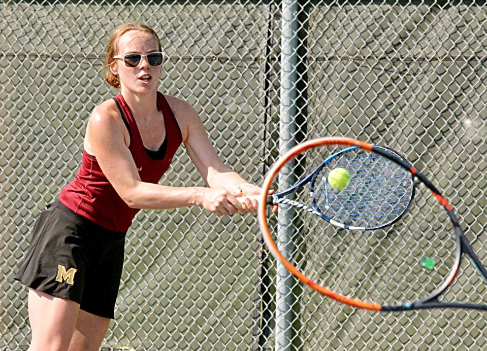 Milbank's Hope Karels hits a return with her partner's racket also pictured during Tuesday's high school girls tennis dual against Watertown.