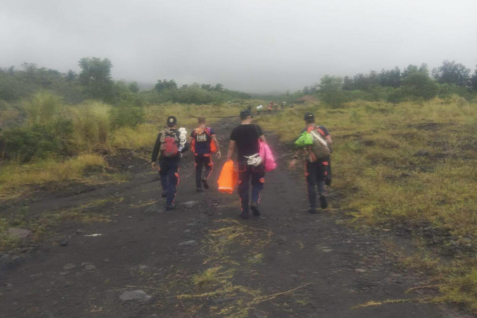 In this handout photo provided by the Bureau of Fire Protection Camalig, rescuers continue their search for passengers of a Cessna 340 aircraft with registry number RP-C2080 at Tumpa Gulley, Camalig town, Albay province, the Philippines on Monday Feb. 20, 2023. Philippine authorities said Monday they would verify whether the wreckage of a small plane spotted near the crater of a restive Mayon volcano was that of a Cessna aircraft that went missing with four people on board over the weekend. (Bureau of Fire Protection Camalig via AP)