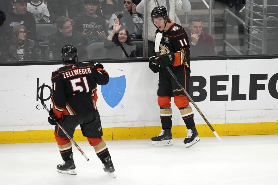 Anaheim Ducks center Trevor Zegras, right, celebrates his goal with defenseman Olen Zellweger during the third period of an NHL hockey game against the Los Angeles Kings Saturday, April 13, 2024, in Los Angeles. (AP Photo/Mark J. Terrill)