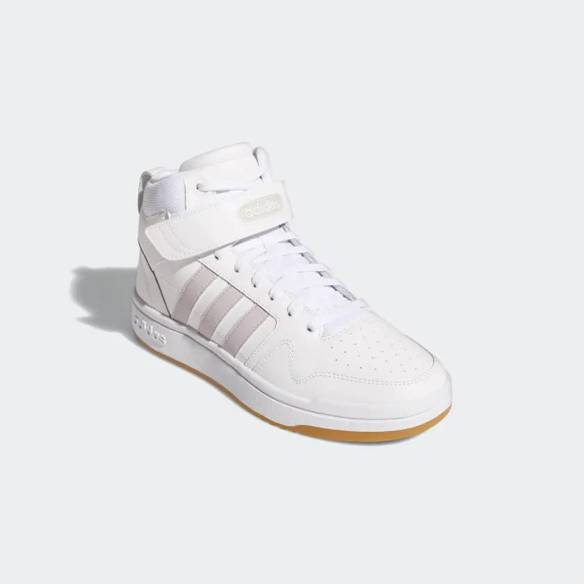 White Adidas sneaker with gum bottom and purple stripes.