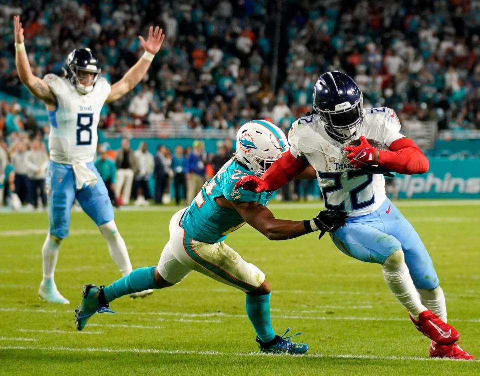 Tennessee Titans running back Derrick Henry (22) runs in a touchdown past Miami Dolphins safety Elijah Campbell (22) during the fourth quarter at Hard Rock Stadium in Miami, Fla., Monday, Dec. 11, 2023.