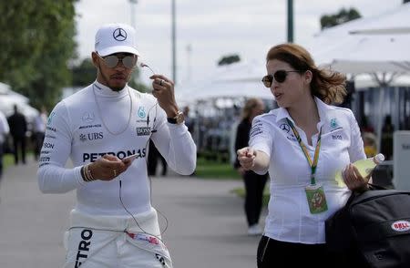 Formula One - F1 - Australian Grand Prix - Melbourne, Australia - 23/03/2017 Mercedes driver Lewis Hamilton (L) of Britain arrives at the driver portrait session at the first race of the year. REUTERS/Jason Reed