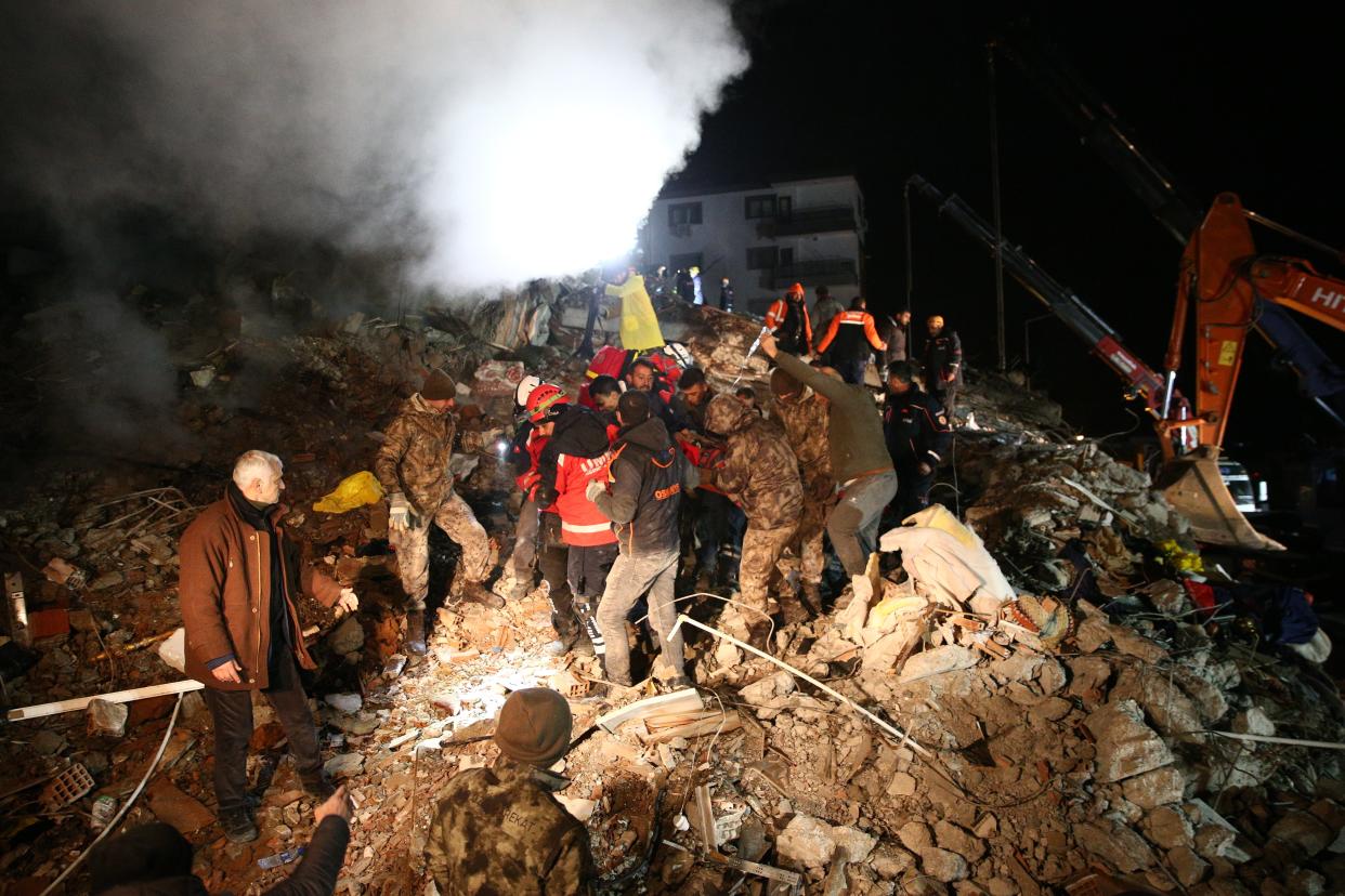 An injured man is being pulled out of the wreckage of a collapsed building in Osmaniye about 26 hours later, as search and rescue operations continue (Anadolu Agency/Getty)