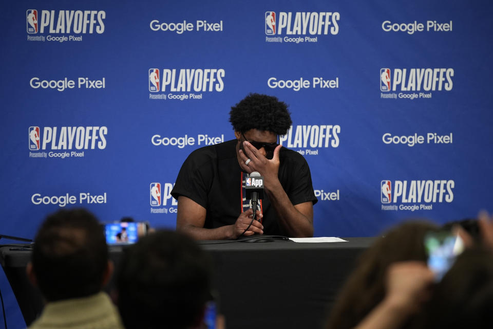 Philadelphia 76ers' Joel Embiid adjusts his glasses while speaking at a news conference after Game 3 in an NBA basketball first-round playoff series against the New York Knicks, Thursday, April 25, 2024, in Philadelphia. (AP Photo/Matt Slocum)