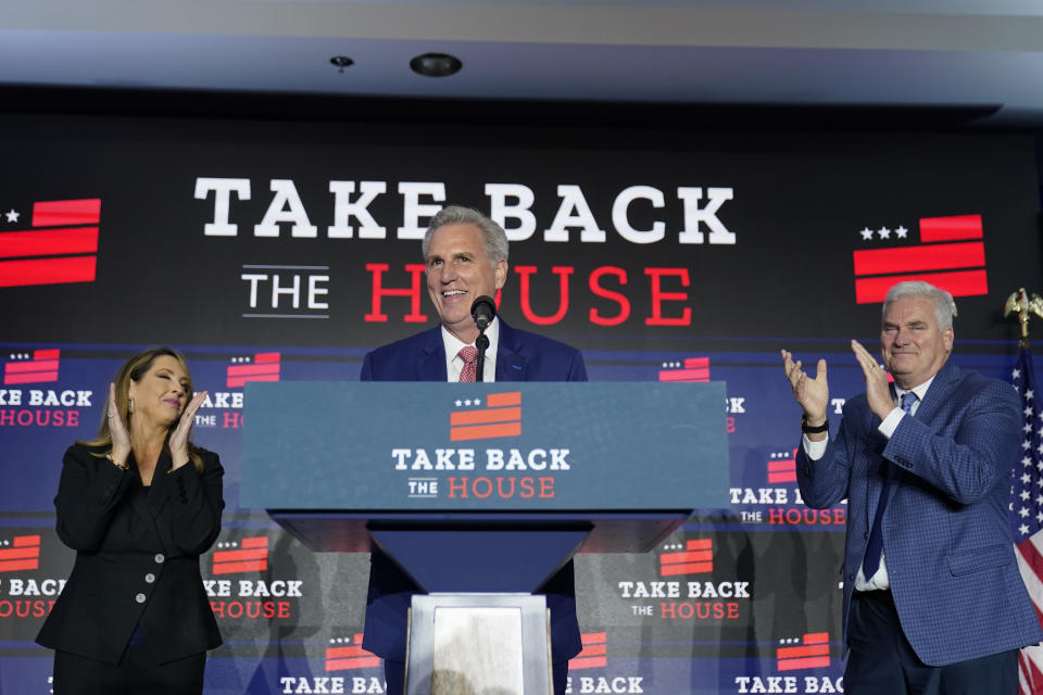 House Minority Leader Kevin McCarthy of Calif., speaks at an election event, early Wednesday, Nov. 9, 2022, in Washington, as Republican National Committee chair Ronna McDaniel, left, and Rep. Tom Emmer, R-Minn., listen. (AP Photo/Alex Brandon)