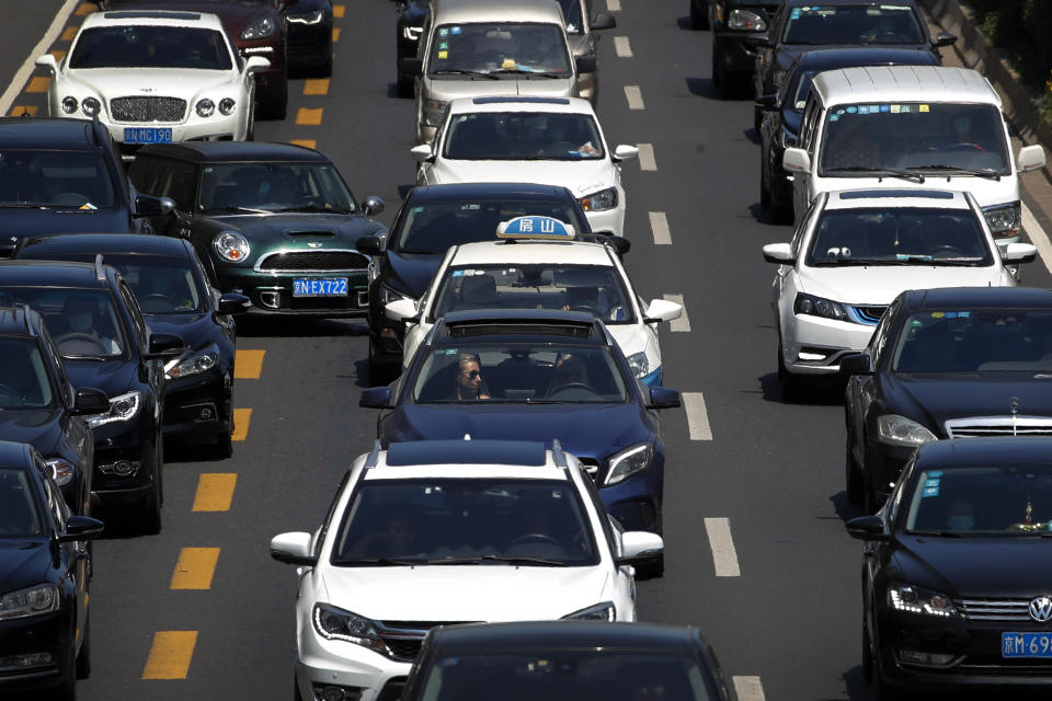 A motorist cuts into center lane as motorists clogged with heavy traffic on a city ring road in Beijing, Tuesday, Aug. 11, 2020. China’s auto sales rose by 16.4% in July over a year earlier to 2.1 million units in a sign of sustained recovery for the industry’s biggest global market, an industry group said Tuesday. (AP Photo/Andy Wong)