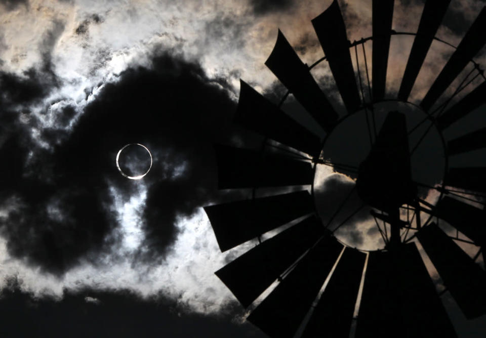 A thundershower rolls through as an annular solar eclipse appears in Gardnerville, Nev., on Sunday, May 20, 2012. (AP Photo/Cathleen Allison)