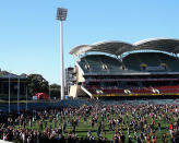 Fans pay tribute to Phil Walsh on the Adelaide Oval surface.