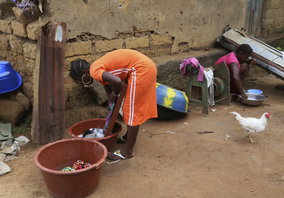 FILE - In this Nov. 8, 2015, file photo, a woman washes clothes in the village of Tanah, situated around 160 kilometers (99 miles) southeast of the capital Conakry, Guinea. One by one, African leaders brought their world to U.N. headquarters. They told stories of illiteracy and malnutrition, about people living with HIV and without electricity. The dance the African leaders must perform at the U.N. General Assembly is delicate. (AP Photo/Youssouf Bah, File)