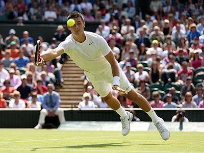 Bernard Tomic of Australia dives to play a forehand during the Gentlemen's Singles third round match against Richard Gasquet of France on day six of the Wimbledon Lawn Tennis Championships at the All England Lawn Tennis and Croquet Club on June 29, 2013 in London, England.