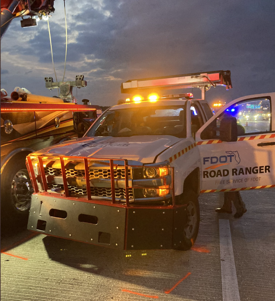 A Florida Department of Transportation Road Ranger remains on the scene of a deadly crash after the truck hit another pickup on the Buckman Bridge, knocking it over the barricade into the St. Johns River on Tuesday in Jacksonville.