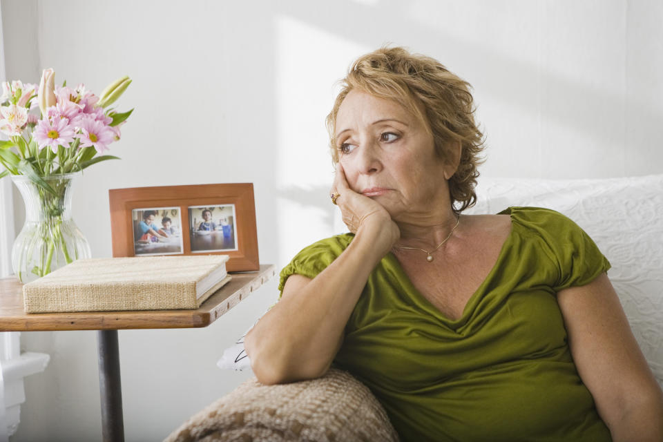 woman sitting with her chin resting in her hand