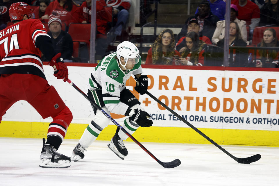 Ty Dellandrea (10) moves the puck around Carolina Hurricanes' Jaccob Slavin (74) during the first period of an NHL hockey game in Raleigh, N.C., Saturday, Feb. 24, 2024. (AP Photo/Karl B DeBlaker)