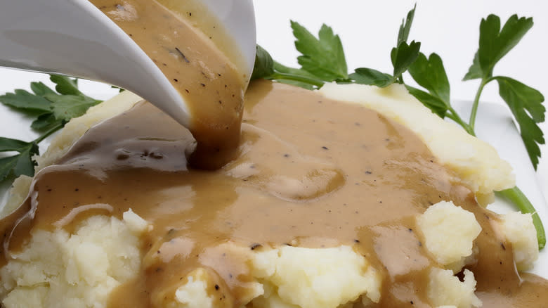 brown gravy poured over mashed potatoes