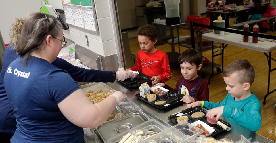 Kindergarten students at Suamico Elementary School go through the hot lunch line on March 8, 2023, in Suamico, Wis.