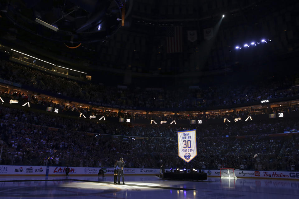 Former Buffalo Sabres goaltender Ryan Miller and his family watch as a banner with his name and number is raised to the rafters before an NHL hockey game between the Sabres and the New York Islanders on Thursday, Jan. 19, 2023, in Buffalo, N.Y. (AP Photo/Joshua Bessex)