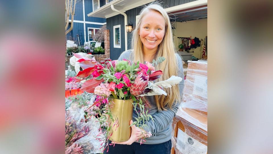 PHOTO:  Ashley Manning holds a flower arrangement that will be donated to a widow in Charlotte, North Carolina, on Feb. 14, 2022. (Ashley Manning )