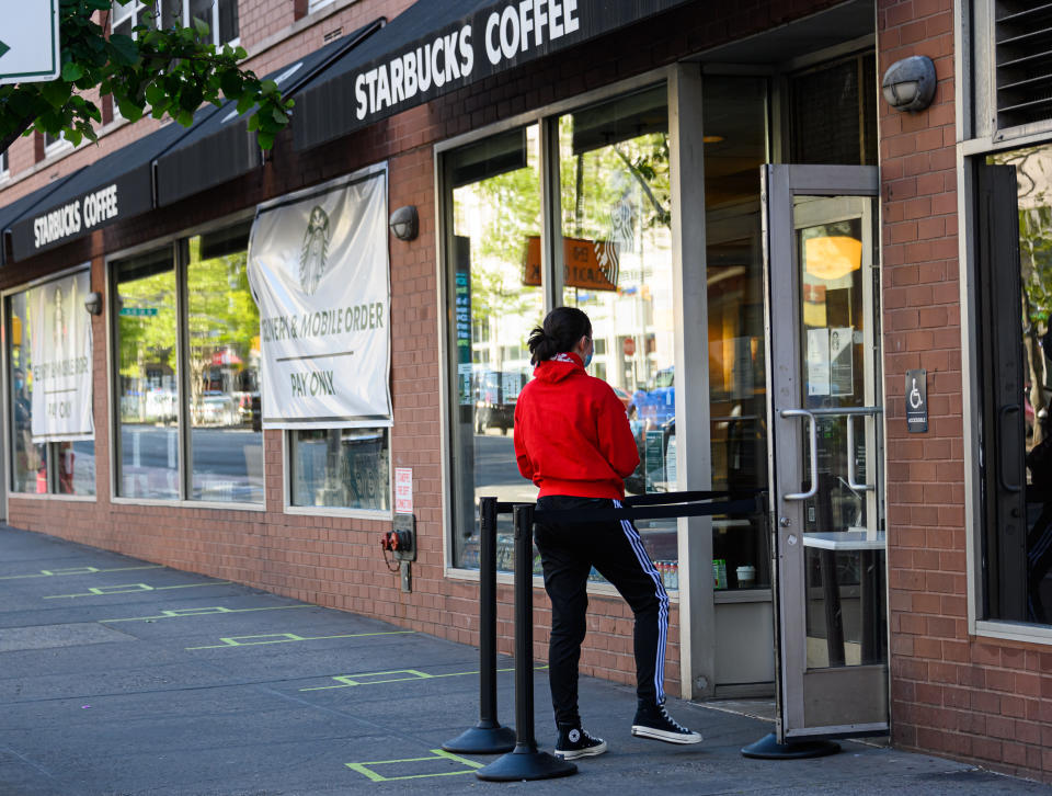 NEW YORK, NEW YORK - MAY 13: A person wears a protective face mask outside Starbucks in Kips Bay during the coronavirus pandemic on May 13, 2020 in New York City. COVID-19 has spread to most countries around the world, claiming over 298,000 lives with over 4.4 million infections reported. (Photo by Noam Galai/Getty Images)