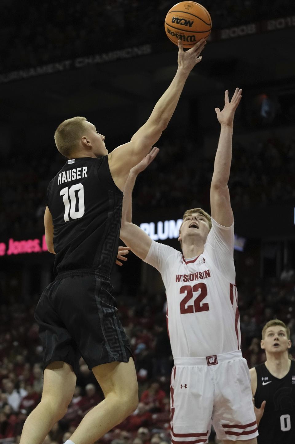 Michigan State's Joey Hauser shoots past Wisconsin's Steven Crowl during the first half of an NCAA college basketball game Tuesday, Jan. 10, 2023, in Madison, Wis.