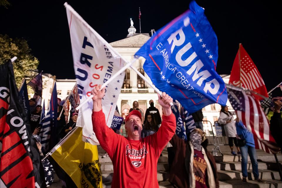 A supporter of President Trump yells at counterprotesters across the street during a rally to protest the election results outside the Georgia State Capitol on Nov. 14. President-elect Joe Biden has been declared the winner in Georgia, becoming the first Democratic nominee to win the state since 1992.