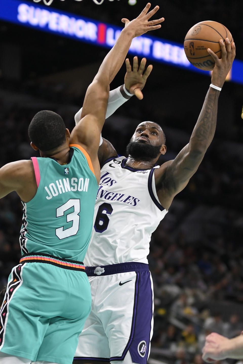 Los Angeles Lakers' LeBron James (6) shoots against San Antonio Spurs' Keldon Johnson during the second half of an NBA basketball game, Friday, Nov. 25, 2022, in San Antonio. (AP Photo/Darren Abate)