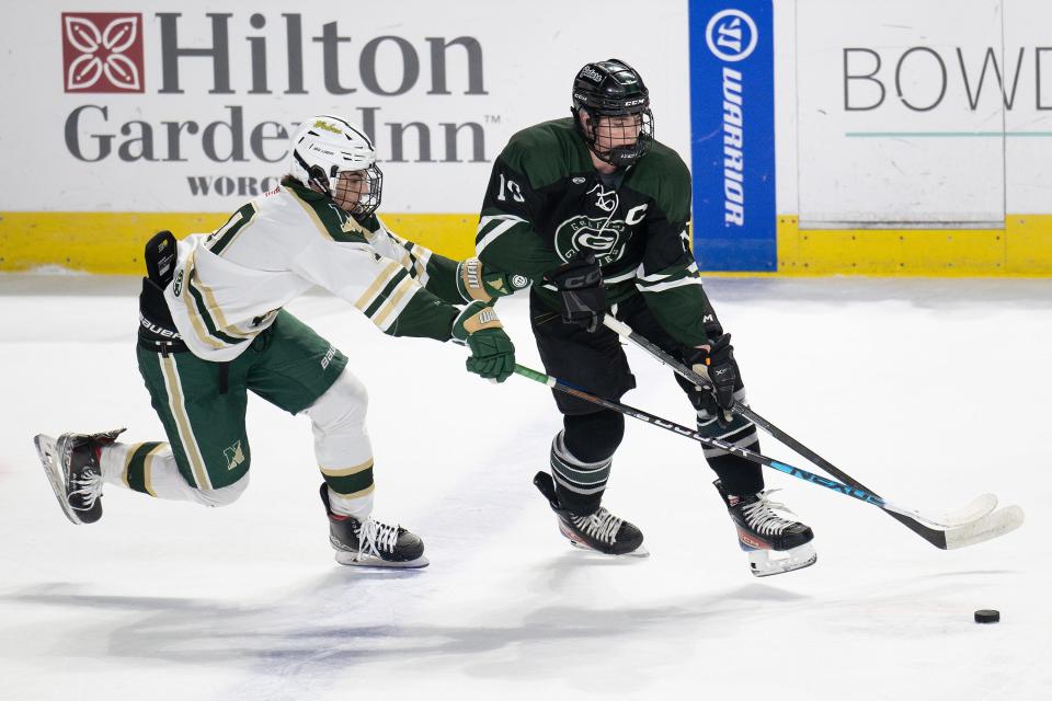 Nashoba's Max Fucillo and Grafton's Zac Terski battle for possession of the puck Saturday at the DCU Center.