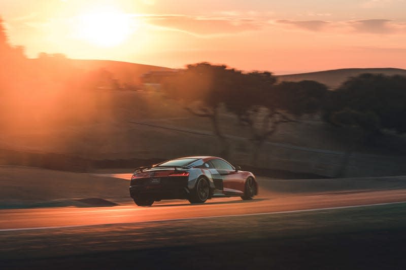 An Audi R8 speeding into the sunset at Laguna Seca Raceway