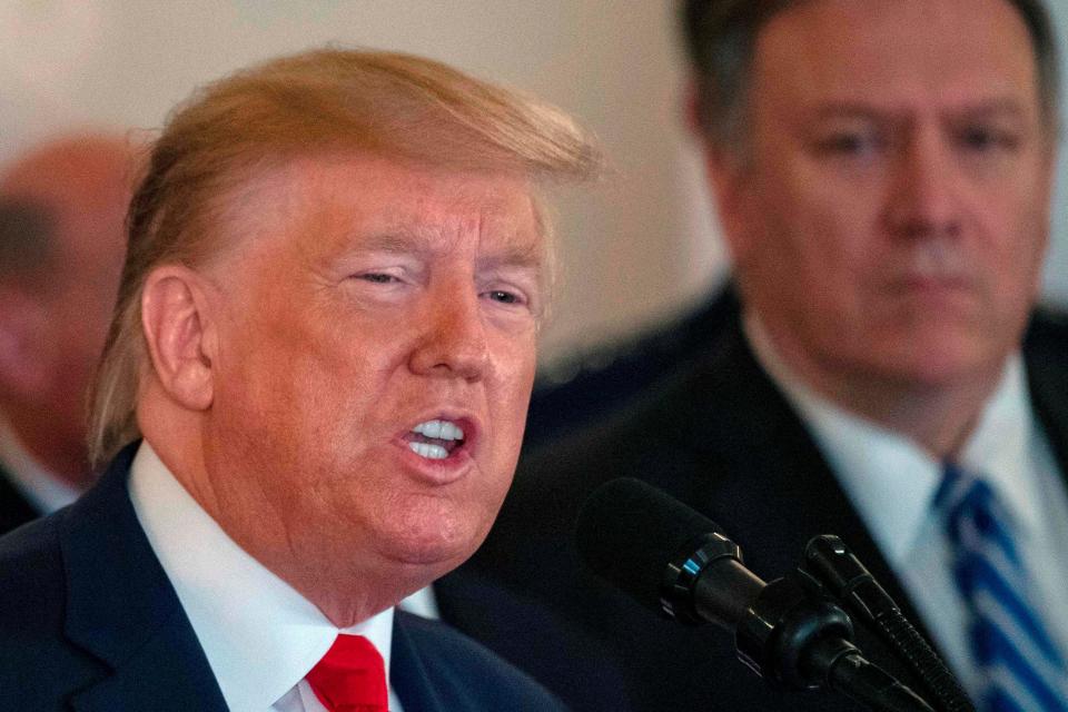 Secretary of State Mike Pompeo listens as President Donald Trump speaks about the situation with Iran on Jan. 8, 2020.