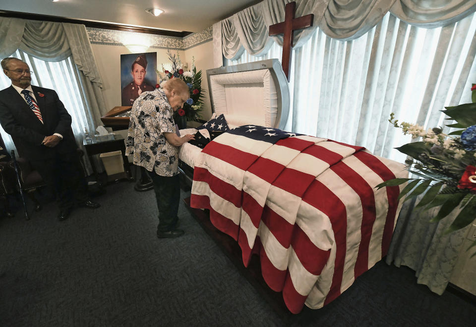 Edna Jenkins, 83, of Scranton, Pa., sister of U.S. Army Pfc. paratrooper Willard "Bud" Jenkins of Scranton, Pa., who was killed in action in 1944 during World War II, stands next to a casket containing his remains on Wednesday, Sept. 27, 2018, at the Edward J. Chomko Funeral Home & Cremation Services in Scranton, Pa. ( Butch Comegys / The Scranton Times-Tribune via AP)