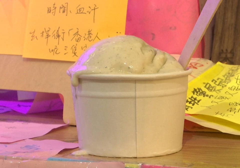 This May 4, 2020, image made from video shows a cup of tear gas flavor ice cream in Hong Kong. A Hong Kong ice cream shop has created this flavor using pepper, in memory of all the tear gas fired by the Hong Kong police in recent months. The flavor is a sign of support for the pro-democracy movement, which is seeking to regain its momentum during the coronavirus pandemic, the shop's owner said. (AP Photo)