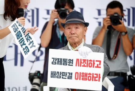 Lee Choon-shik, a victim of wartime forced labor during the Japanese colonial period, reacts as he attends during an anti-Japan protest on Liberation Day in Seoul