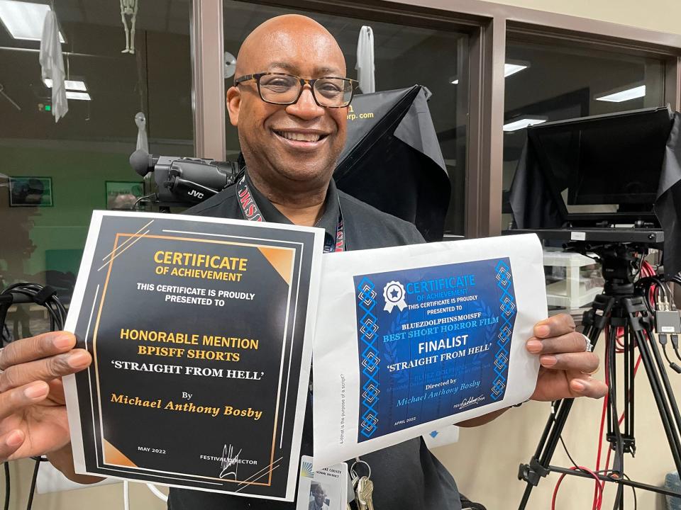 Athens Community Career Academy film instructor Michael Bosby displaying the awards won by his short horror film "Straight From Hell" in Athens, Ga. on May 11, 2022.