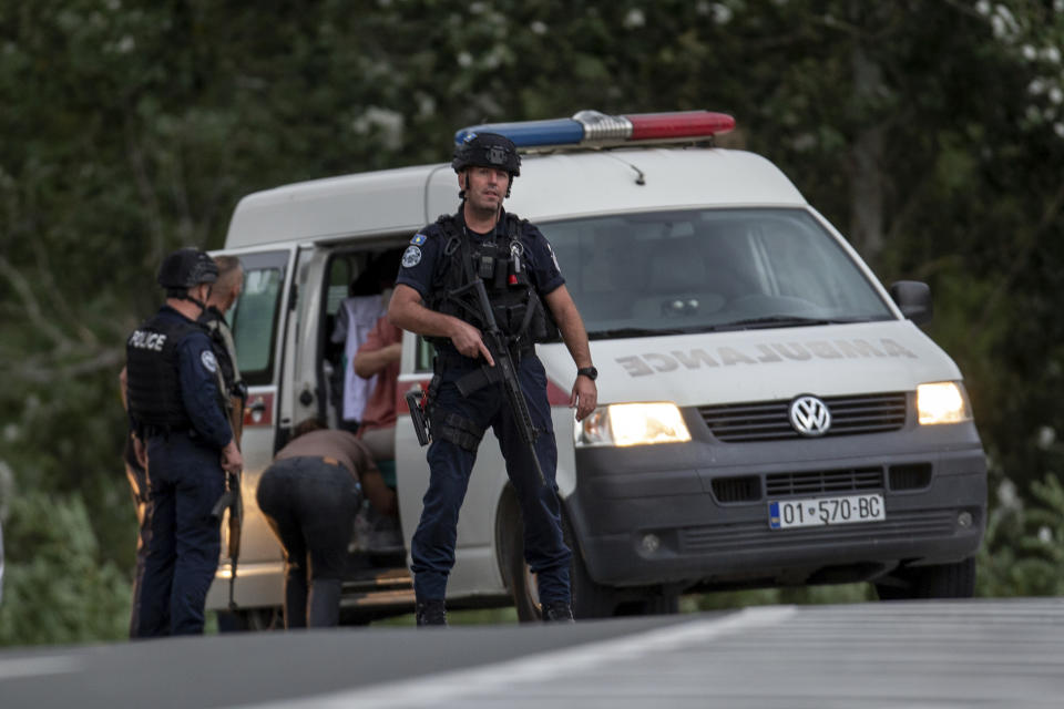 Kosovo police officers evacuate a wounded person at a cross road leading to the Banjska Monastery in the village of Banjska on Sunday, Sept.24, 2023. Kosovo's prime minister on Sunday said one police officer was killed and another wounded in an attack he blamed on support from neighboring Serbia, increasing tensions between the two former war foes at a delicate moment in their European Union-facilitated dialogue to normalize ties.(AP Photo/Visar Kryeziu)