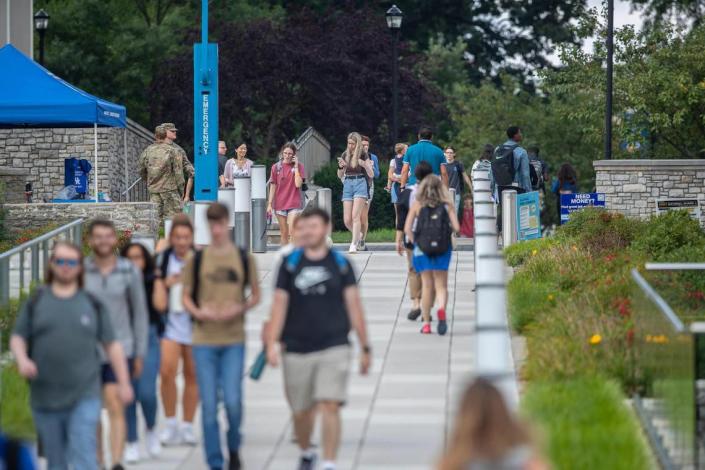 People walk along the University of Kentucky campus in Lexington, Ky., on Monday, Aug. 22, 2022.