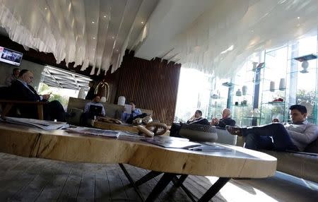 People sit in the lobby of a hotel where the electric vehicle maker Tesla is holding a recruiting event for its California factory, in the municipality of San Pedro Garza, neighbouring Monterrey, May 5, 2017. REUTERS/Daniel Becerril