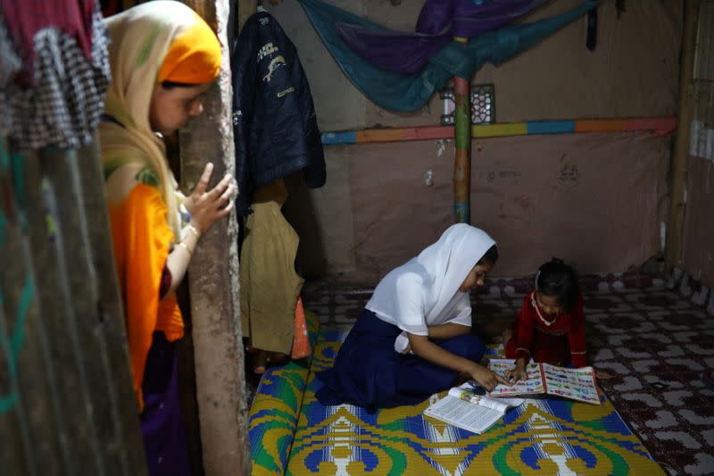 Yasmin, a Rohingya girl who was expelled from Leda High School for being a Rohingya, helps her younger sister to study in Leda camp in Teknaf