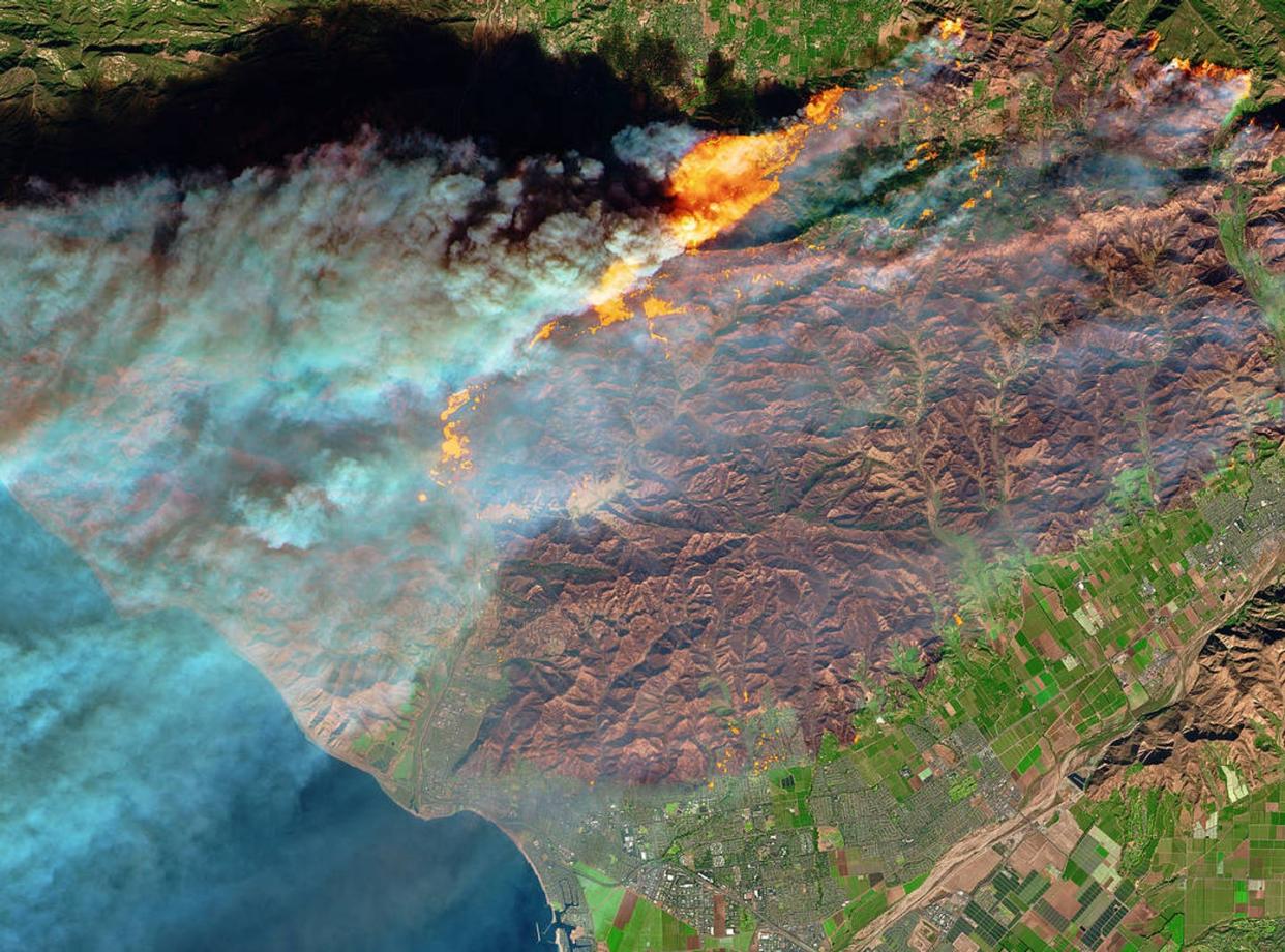 <span class="caption">Satellites can quickly detect and monitor wildfires from space, like this 2017 fire that encroached on Ventura, California.</span> <span class="attribution"><a class="link " href="https://www.nasa.gov/image-feature/fire-in-ventura-county-california" rel="nofollow noopener" target="_blank" data-ylk="slk:NASA Earth Observatory/Joshua Stevens;elm:context_link;itc:0;sec:content-canvas">NASA Earth Observatory/Joshua Stevens</a></span>