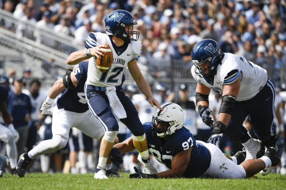 Villanova quarterback Daniel Smith (12) is sacked by Penn State defensive tackle PJ Mustipher (97) in the second quarter during an NCAA college football game in State College, Pa., on Saturday, Sept. 25, 2021. (AP Photo/Barry Reeger)