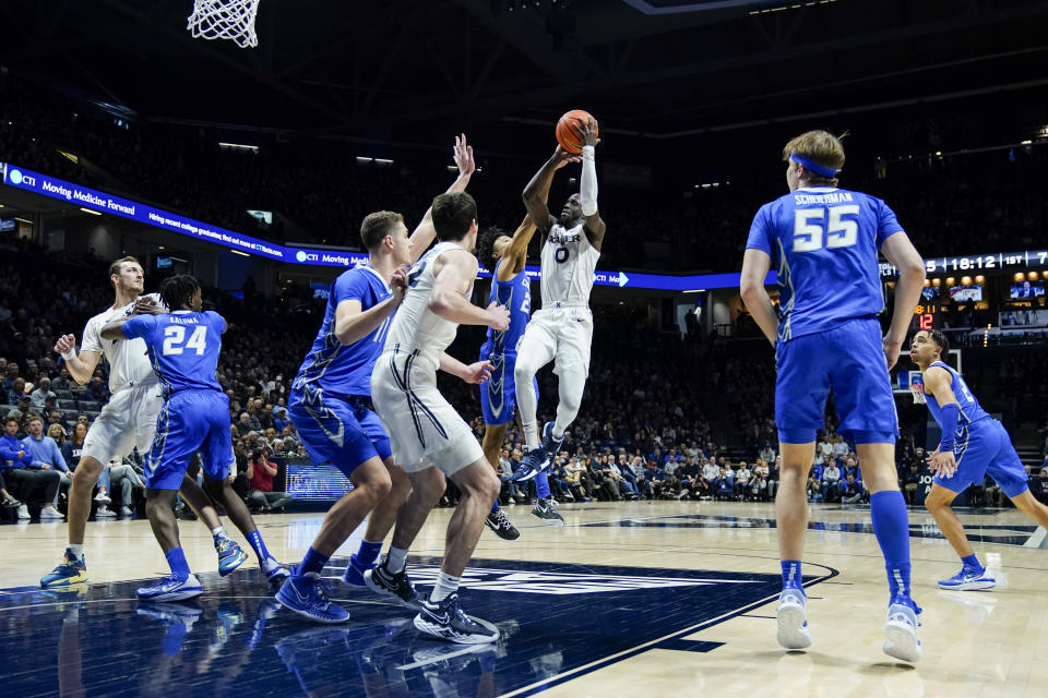 Xavier guard Souley Boum (0) shoots against Creighton's Trey Alexander during the first half of an NCAA college basketball game, Wednesday, Jan. 11, 2023, in Cincinnati. (AP Photo/Jeff Dean)