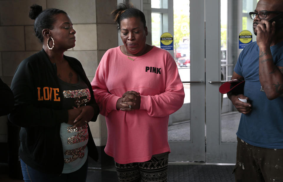 Karen Carter, center, the mother of Ashley Hall, a shoplifting suspect shot by a Ladue police officer last month, awaits a press conference with Hall's father, Robert Hall, Sr., and Aigner Hall, Hall's sister, at the St. Louis County Justice Center on Wednesday, May 1, 2019 in Clayton Mo. Julia Crews, a 13-year police officer, was charged Wednesday with second-degree assault by St. Louis County Prosecutor Wesley Bell. (Robert Cohen/St. Louis Post-Dispatch via AP)