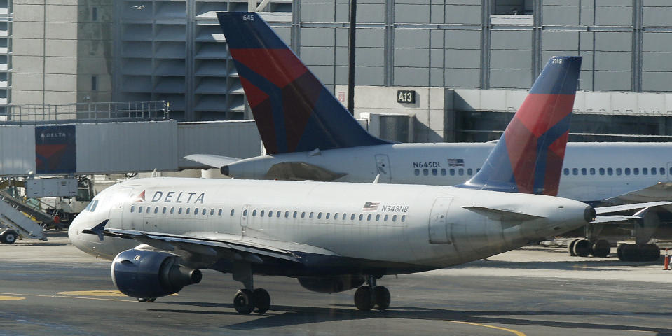 FILE- In this Tuesday, Jan. 24, 2012, file photo, a Delta Airlines plane taxis past a gate at Logan Airport in Boston. Police at Amsterdam's Schiphol Airport have opened a criminal investigation into how needles got into turkey sandwiches served to passengers on Delta Air Lines flights from Amsterdam to the United States, a spokesman said Tuesday. July 17, 2012. The FBI also is investigating the incidents. (AP Photo/Charles Krupa, File)